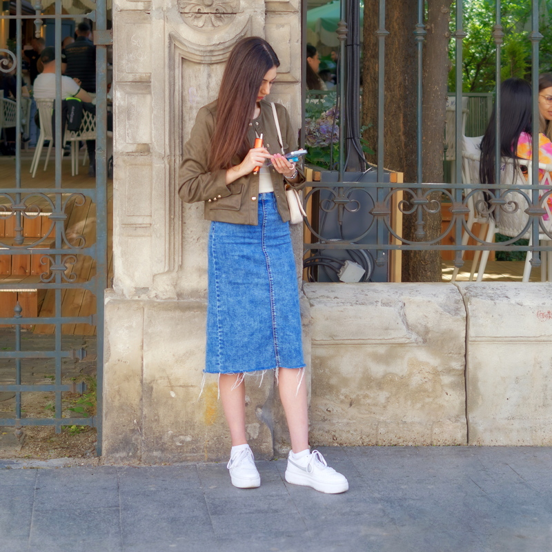 Girl standing in front of a stone structure of a cafe